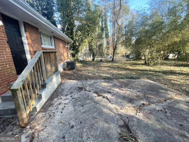 view of yard with a patio and central air condition unit