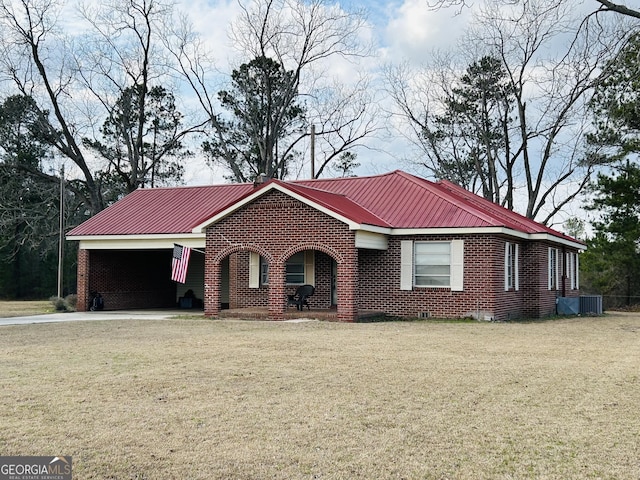 ranch-style house featuring a carport and a front yard