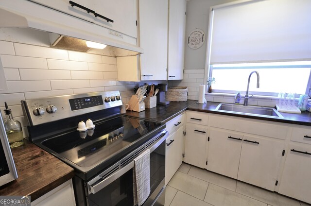 kitchen with stainless steel range with electric stovetop, sink, decorative backsplash, and white cabinets