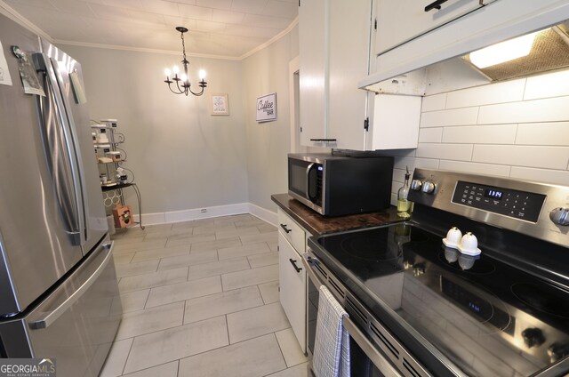 kitchen featuring pendant lighting, white cabinetry, stainless steel appliances, ornamental molding, and decorative backsplash