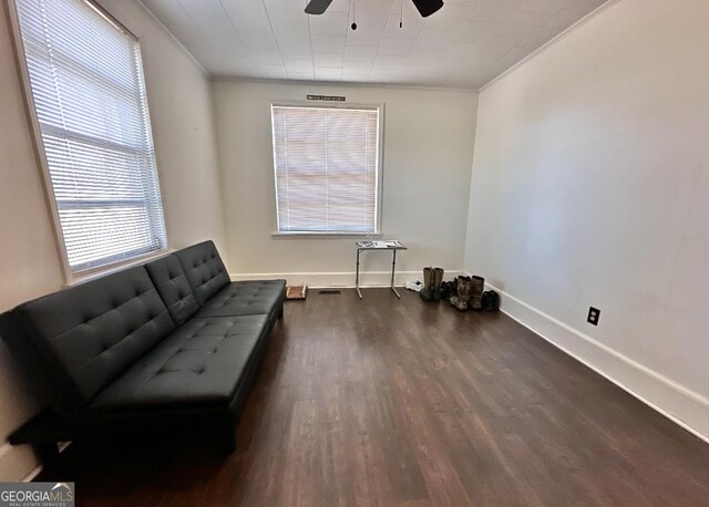 sitting room featuring ceiling fan, ornamental molding, and dark hardwood / wood-style flooring