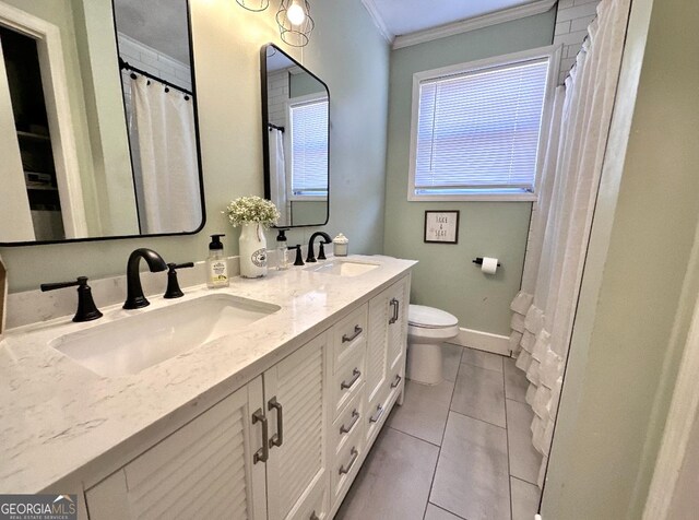 bathroom featuring vanity, tile patterned flooring, ornamental molding, and toilet