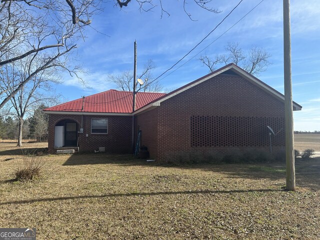 rear view of house with a lawn