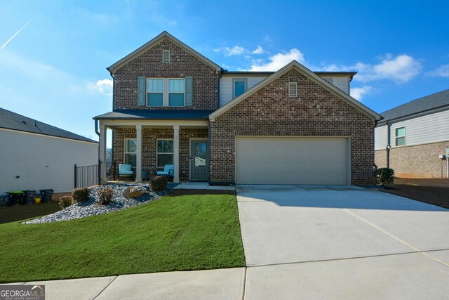 view of front of property with a garage, a porch, and a front lawn