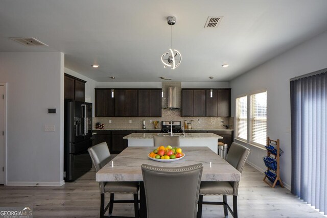 dining space featuring sink and light wood-type flooring