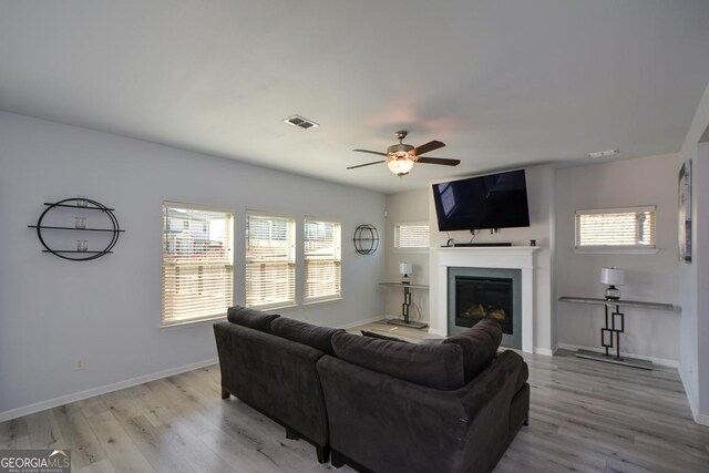 living room featuring ceiling fan and light wood-type flooring