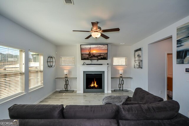 living room featuring ceiling fan and light wood-type flooring