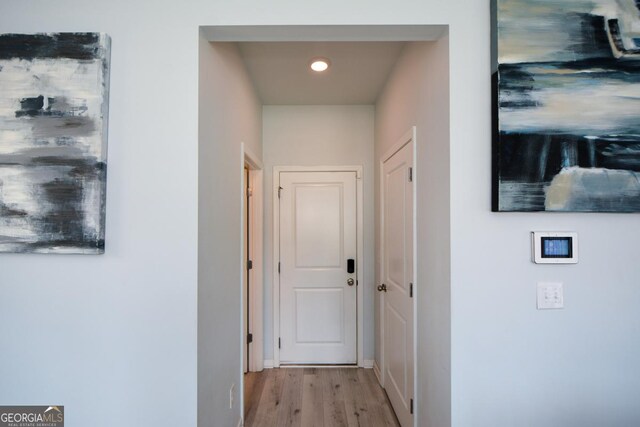 corridor with light hardwood / wood-style flooring