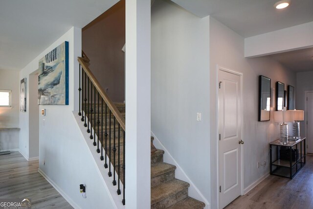 staircase with hardwood / wood-style flooring