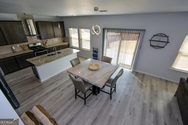 dining space with sink and light hardwood / wood-style flooring