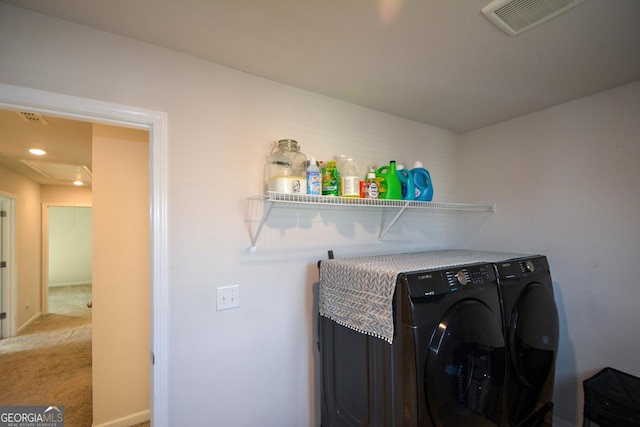 laundry room featuring washing machine and clothes dryer and carpet