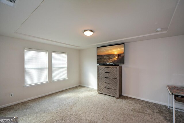 unfurnished bedroom featuring light carpet