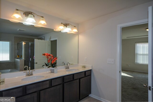 bathroom with vanity and independent shower and bath