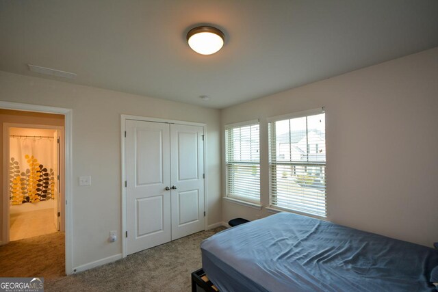 carpeted bedroom featuring a closet