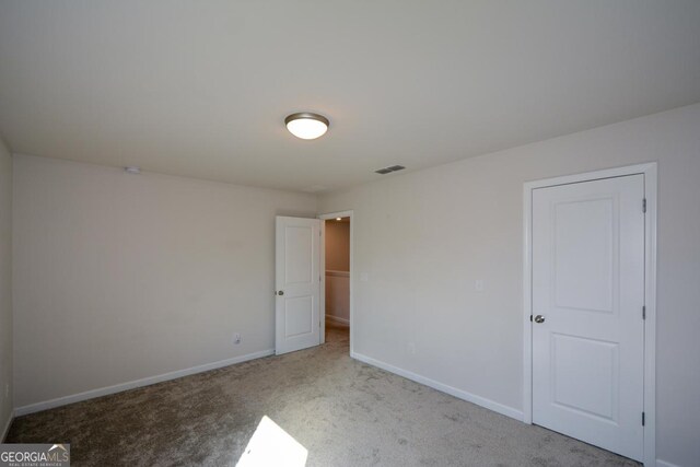 empty room featuring light colored carpet