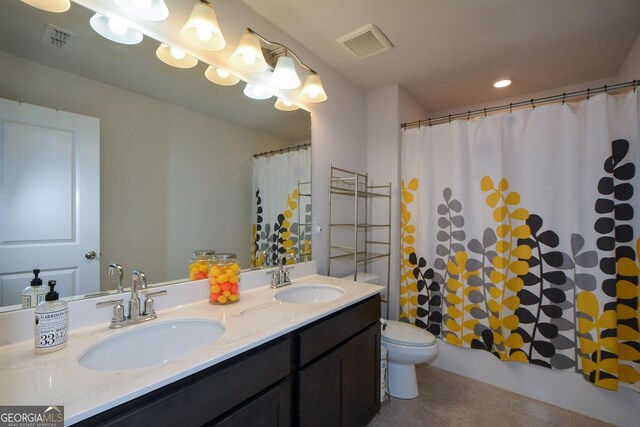 full bathroom with shower / bath combination with curtain, vanity, tile patterned floors, and toilet