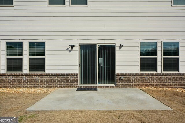 property entrance with a patio area