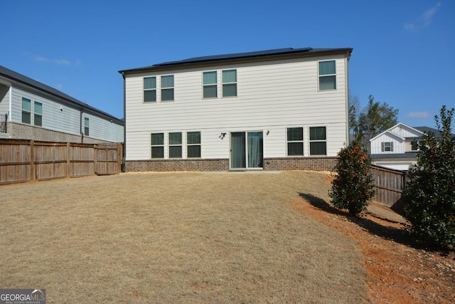 back of property featuring solar panels