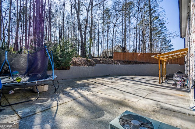 view of patio with a trampoline and cooling unit