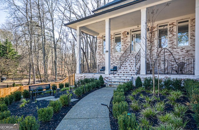 view of exterior entry featuring a porch