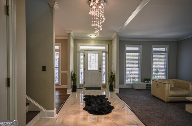 entrance foyer featuring crown molding and an inviting chandelier