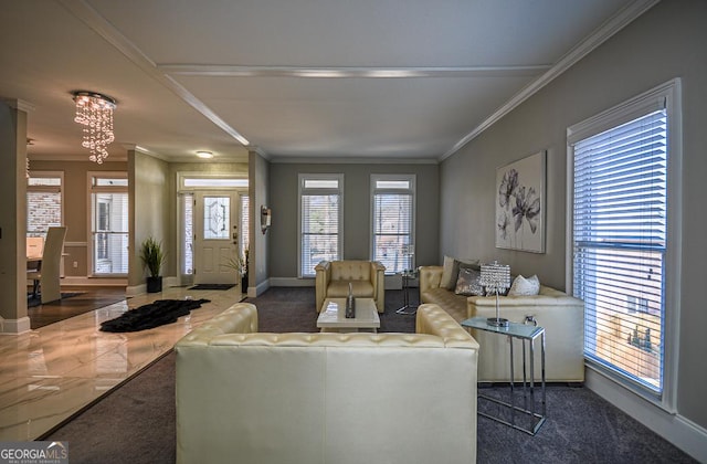 living room featuring dark colored carpet, ornamental molding, and a notable chandelier