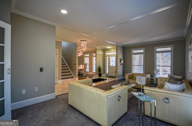 living room featuring ornamental molding, dark carpet, and a notable chandelier