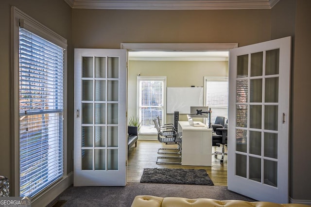 home office featuring hardwood / wood-style flooring, ornamental molding, and a wealth of natural light