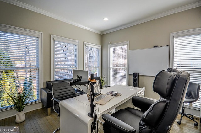 home office with ornamental molding, a wealth of natural light, and light hardwood / wood-style floors