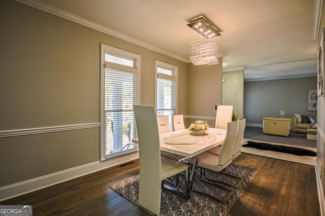 dining area featuring crown molding, a chandelier, and dark hardwood / wood-style flooring