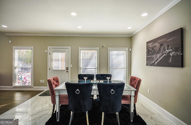 dining space featuring crown molding