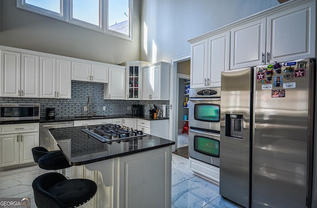 kitchen with appliances with stainless steel finishes, sink, and white cabinets