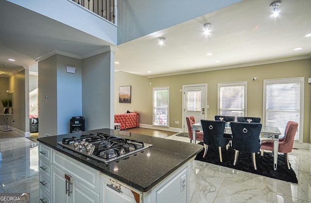 kitchen with white cabinetry, crown molding, and stainless steel gas cooktop