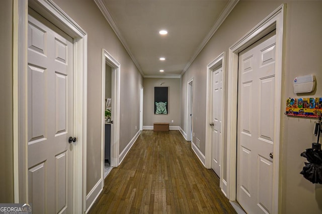 hall featuring crown molding and dark wood-type flooring