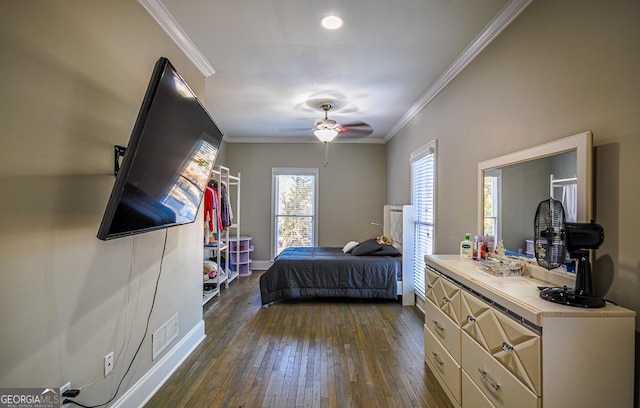 bedroom with crown molding, ceiling fan, and dark wood-type flooring