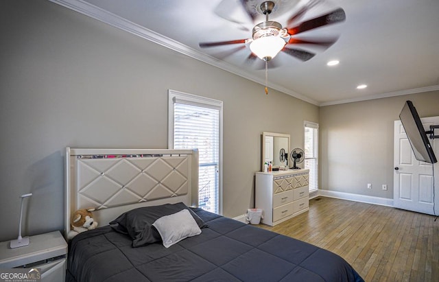 bedroom featuring ceiling fan, ornamental molding, and light hardwood / wood-style floors