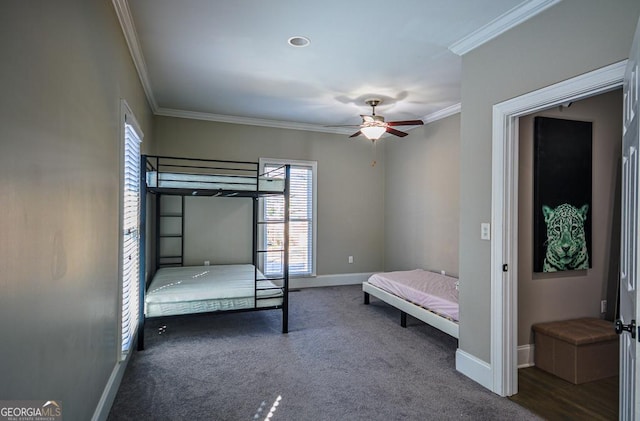 unfurnished bedroom featuring crown molding, ceiling fan, and dark carpet