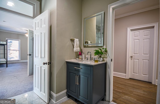 bathroom with ceiling fan, ornamental molding, and vanity