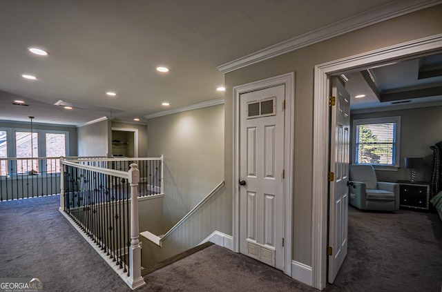 corridor featuring ornamental molding and dark carpet