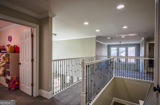 hallway featuring ornamental molding and carpet flooring