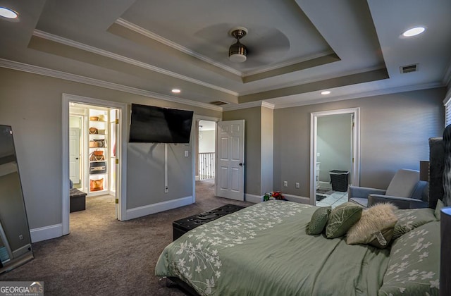 bedroom featuring crown molding, carpet, and a tray ceiling