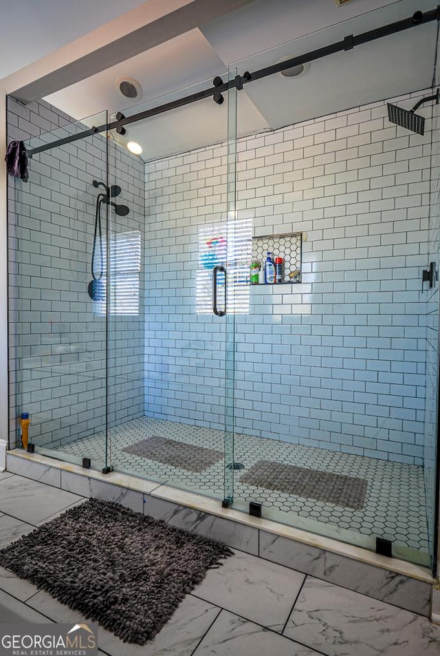 bathroom with a shower with door