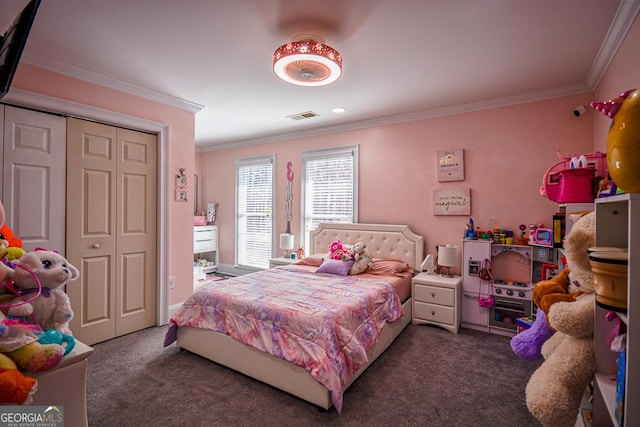 bedroom with crown molding, a closet, and dark colored carpet