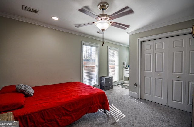 bedroom with ceiling fan, a closet, ornamental molding, and carpet