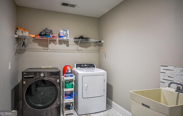 laundry area featuring sink and independent washer and dryer