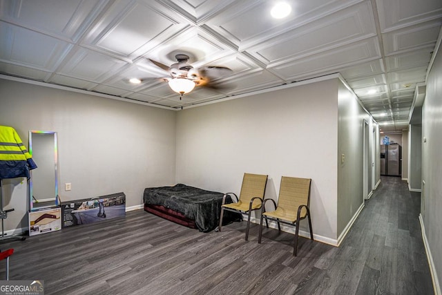 bedroom with dark hardwood / wood-style floors and stainless steel refrigerator with ice dispenser