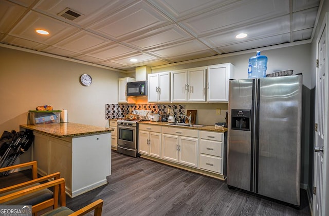 kitchen with stainless steel appliances, stone countertops, sink, and white cabinets