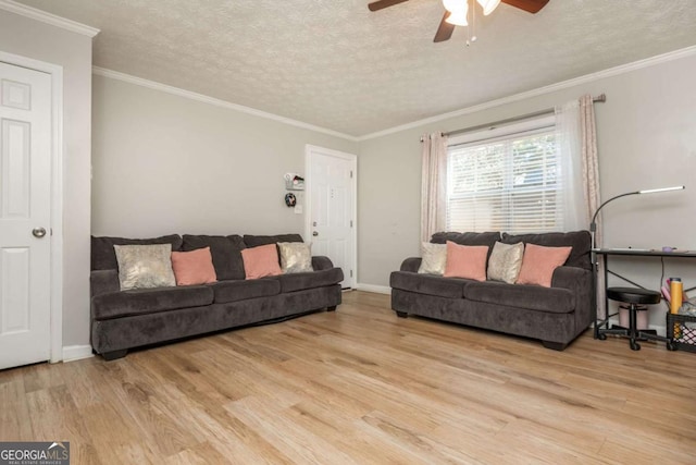 living room featuring crown molding, ceiling fan, light hardwood / wood-style flooring, and a textured ceiling