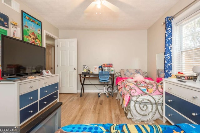 bedroom with ceiling fan and light hardwood / wood-style floors