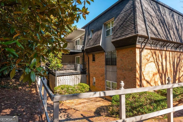 view of side of home featuring a balcony